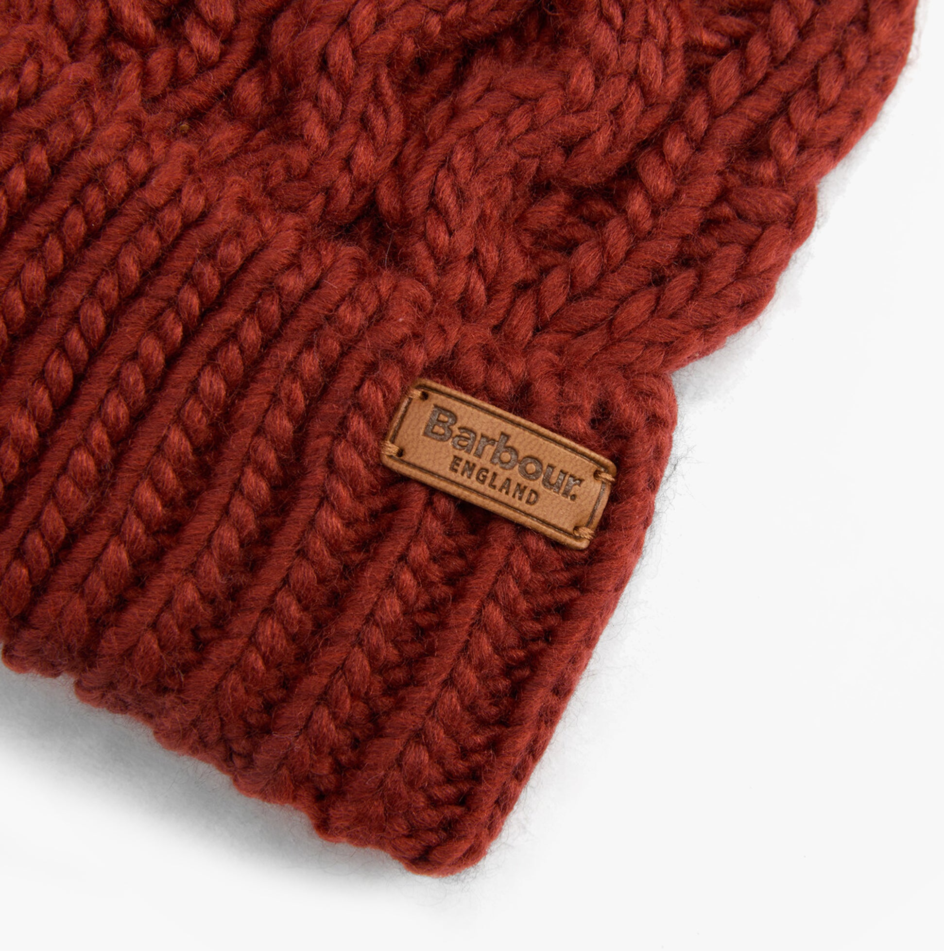 Barbour PENSHAW Womens Beanie Burnt Henna detail view showcasing knit pattern and logo label.