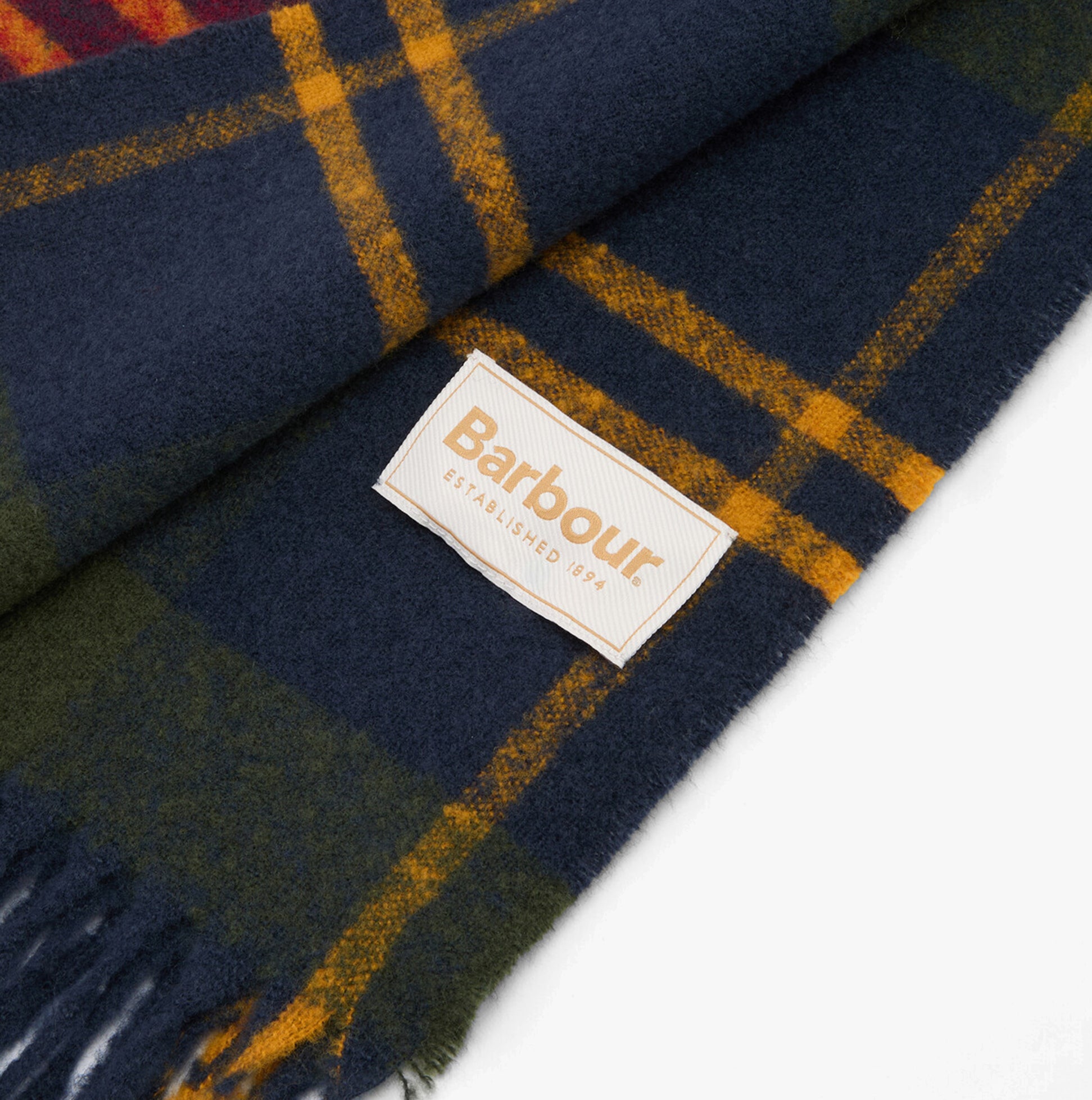 Barbour DEANNA TARTAN Womens Winter Winterberry Tartan detail view with logo on navy plaid fabric.