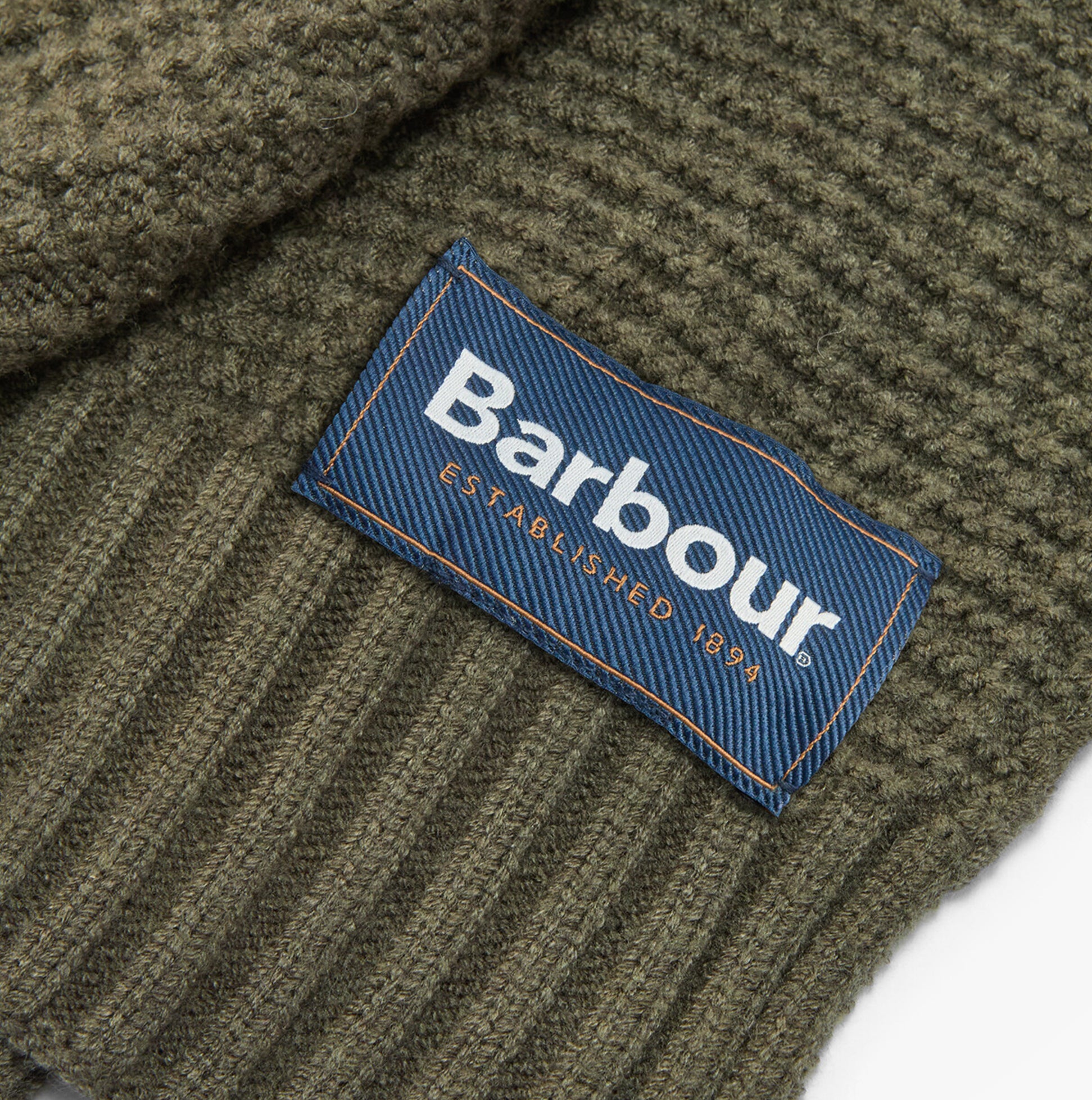 Barbour RAMSIDE BEANIE AND SCARF Mens Gift Set Dark Olive detail view of label on beanie showing brand logo.