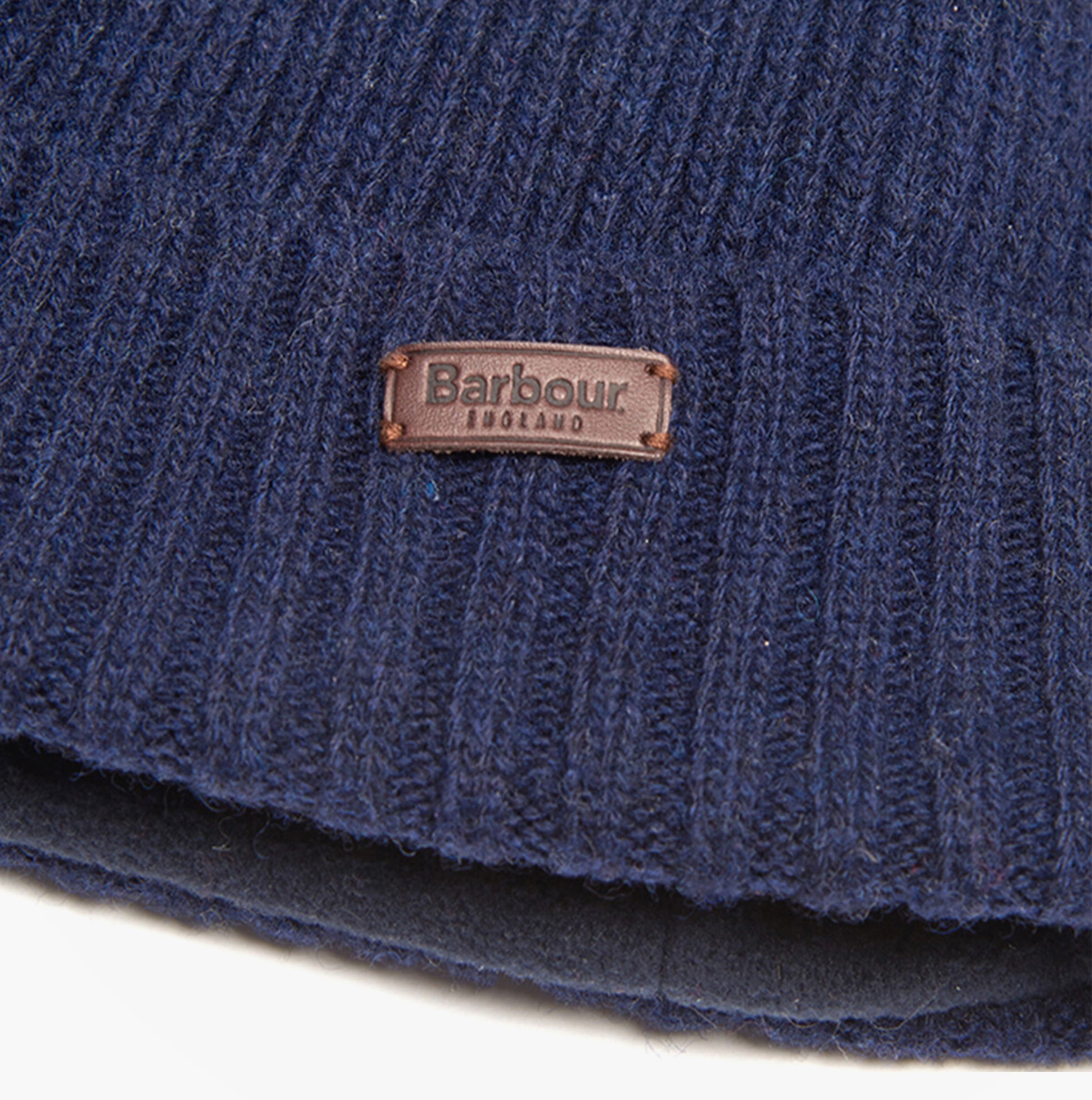 Barbour CARLTON Mens Beanie Navy detail view showing logo and texture of the beanie, highlighting quality materials.