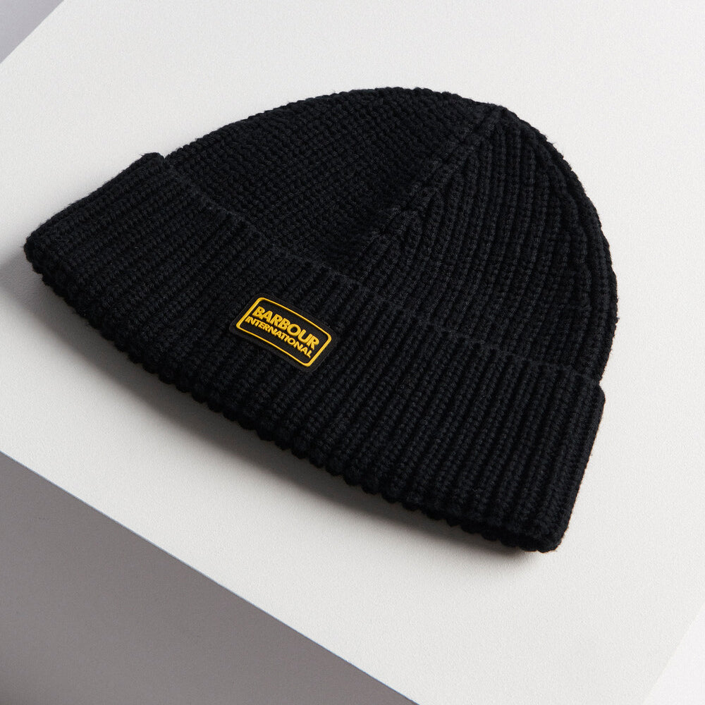 Barbour SWEEPER LEGACY Mens Beanie Black side view showing ribbed texture and silicone logo badge.