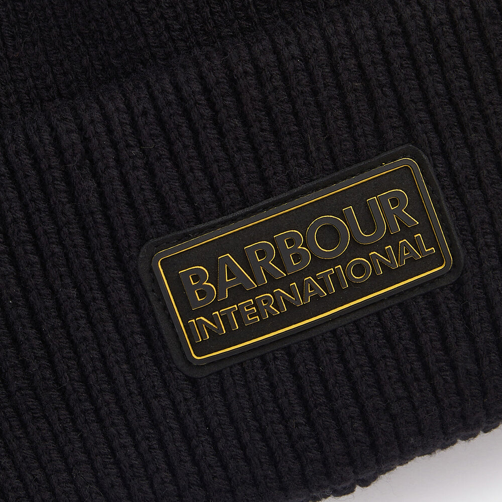 Barbour FLEX Mens Beanie Black close-up view of rubberised branded badge on outer.