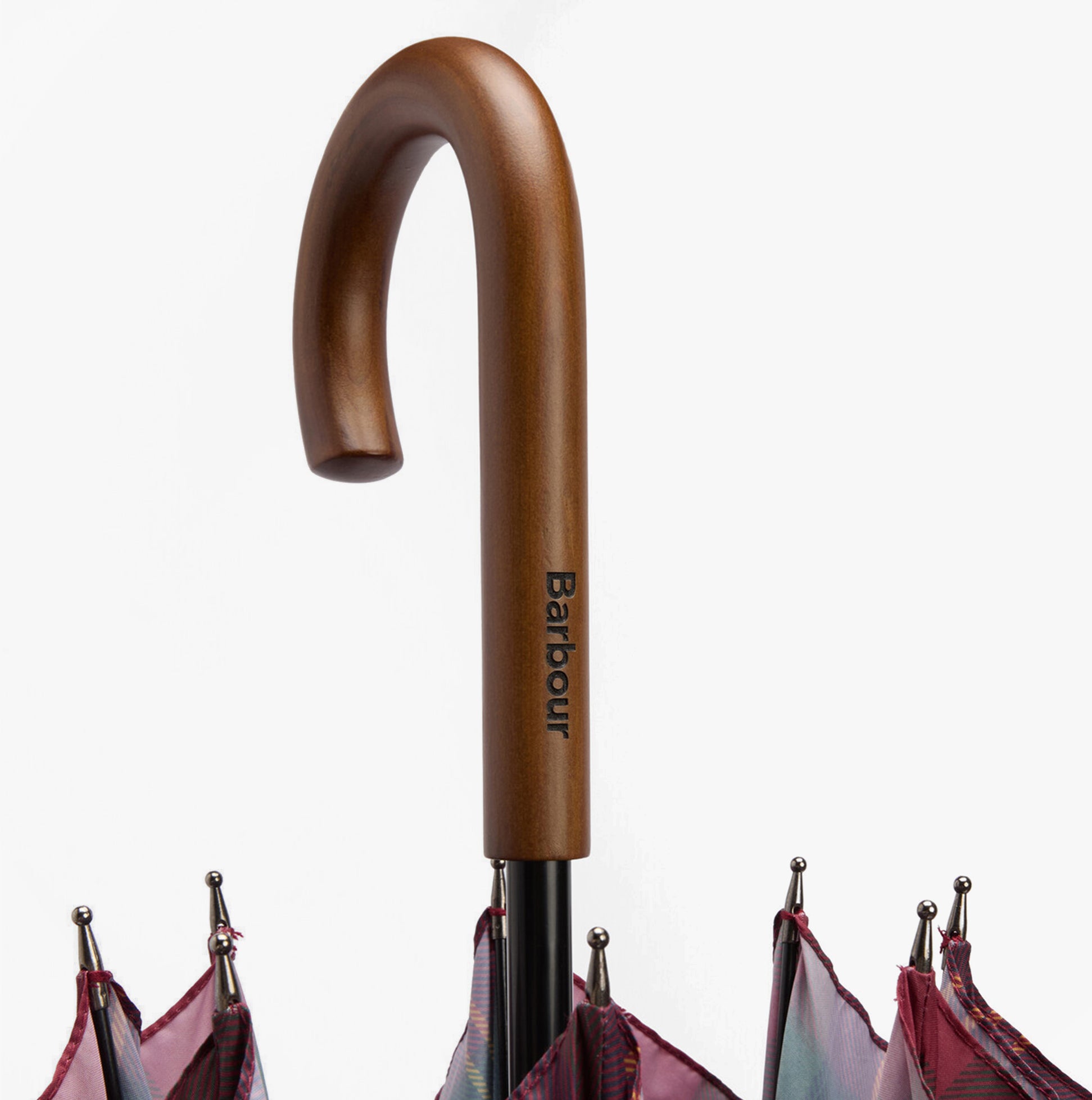 Barbour Tartan Walker Umbrella detail view of the wooden handle showcasing the Barbour logo and colorful canopy fabric.