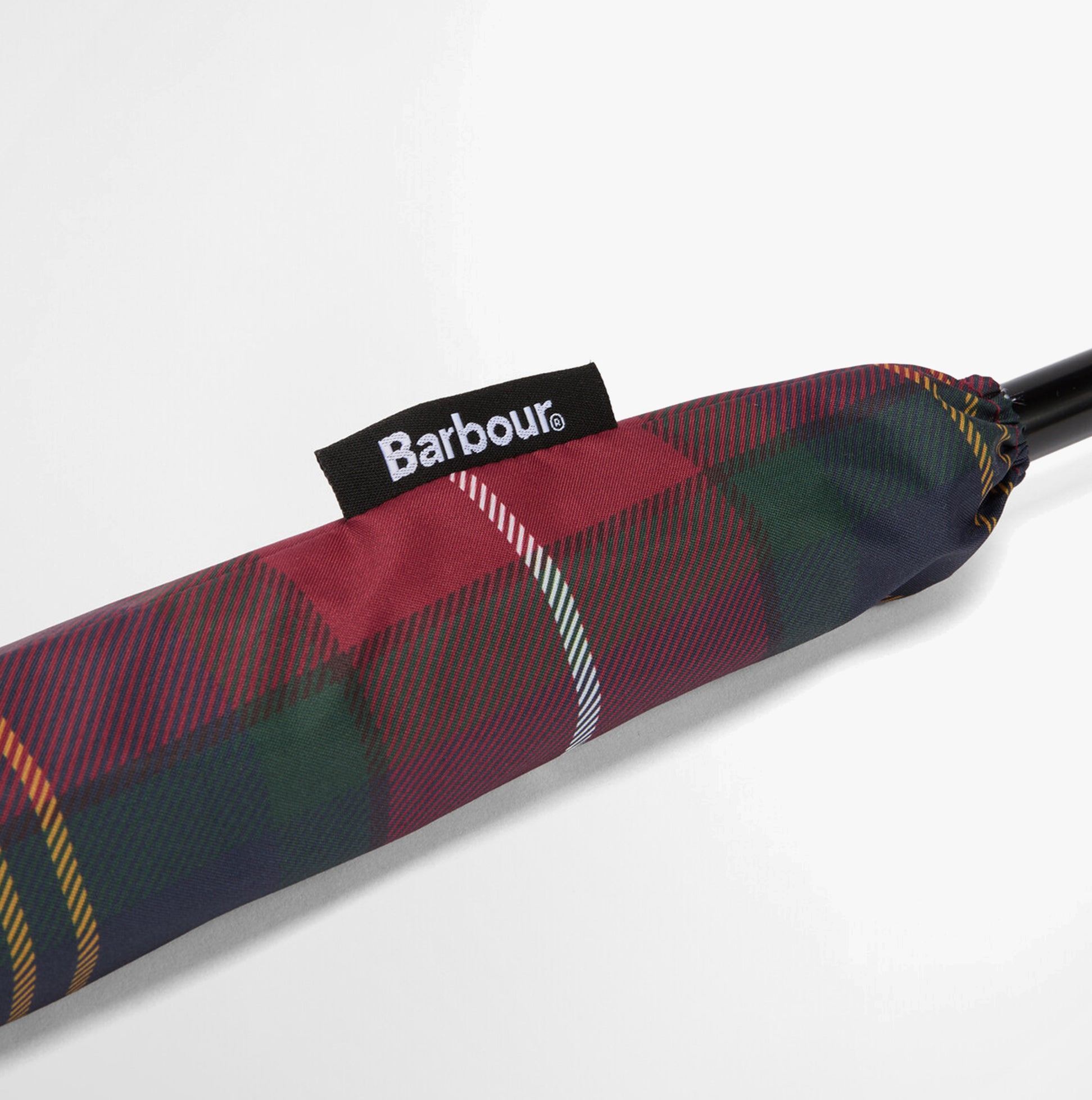 Barbour Tartan Walker Umbrella detail view of the canopy sleeve showing tartan design and Barbour label.