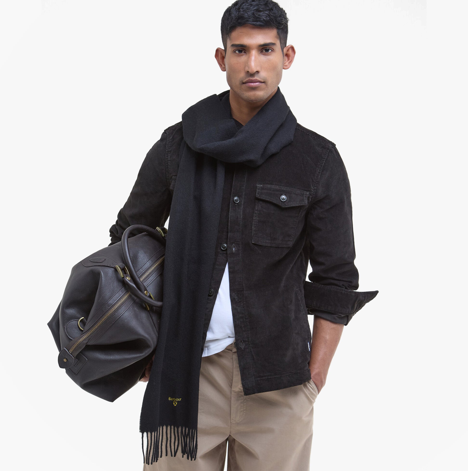 Barbour PLAIN LAMBSWOOL Mens Winter Black worn with a black jacket, side view, model carrying a leather bag.