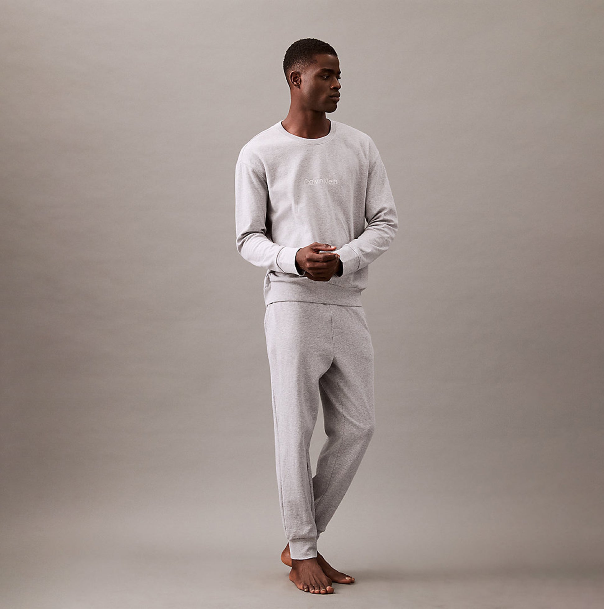 Calvin Klein ICON COTTON TERRY Mens Sweatshirt Medium Grey Heather front view on model, showcasing crew neckline and rib-knit details.