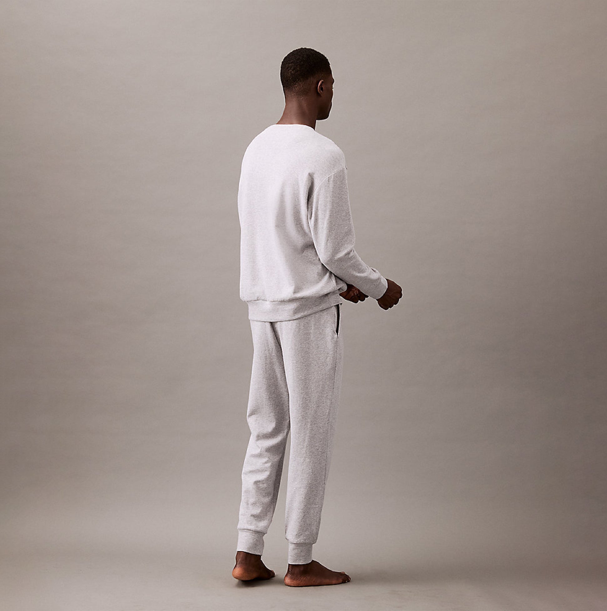 Calvin Klein ICON COTTON TERRY Mens Sweatshirt Medium Grey Heather back view model wearing sweatshirt and pants