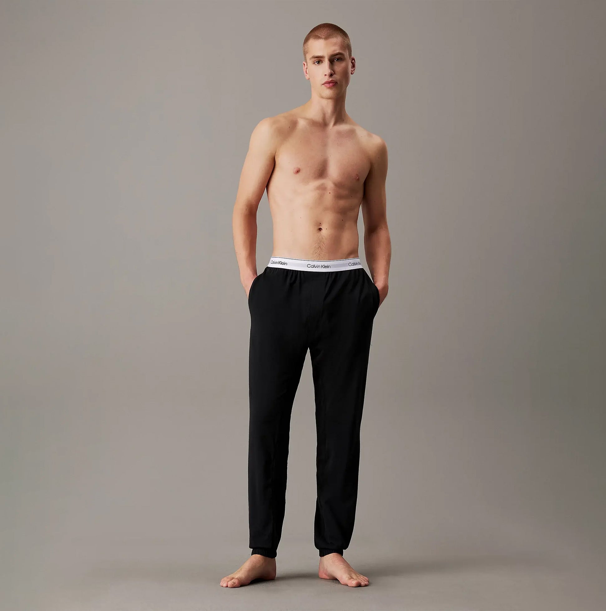 Calvin Klein ICON COTTON STRETCH Mens Lounge Joggers Black front view on model with hands in pockets.