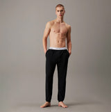 Calvin Klein ICON COTTON STRETCH Mens Lounge Joggers Black front view on model with hands in pockets.