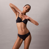 Calvin Klein Womens Invisible 3 Pack Thong Multi, side view of model in dark underwear, showcasing fit and style.