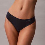Calvin Klein Womens Invisible 3 Pack Thong Multi side view of black thong on model showcasing fit and style.