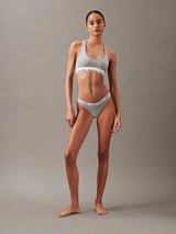 Calvin Klein MODERN LOGO Womens Thong Grey Heather front view on model, showcasing cotton stretch blend and CK signature waistband.