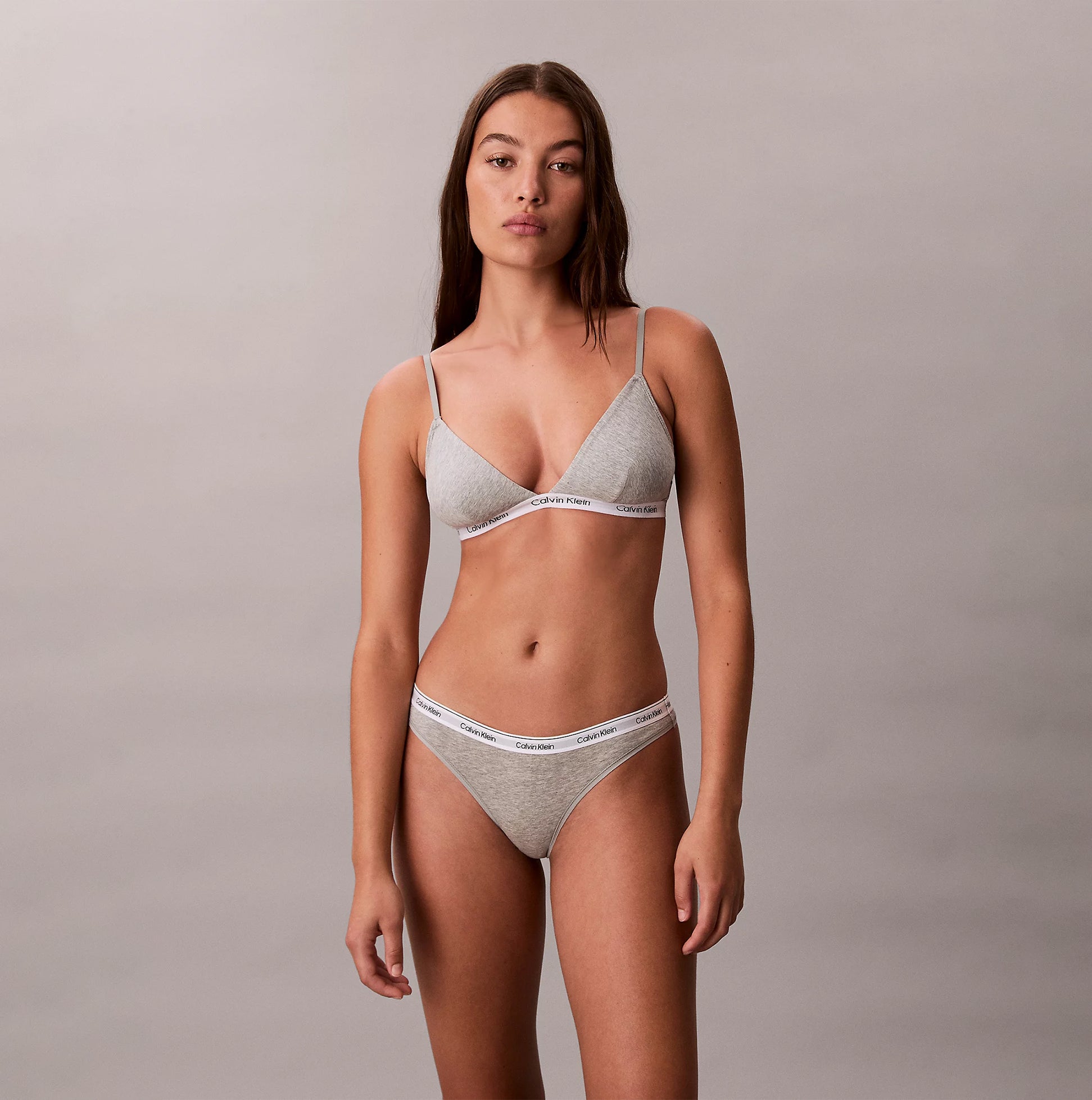 Calvin Klein Icon Logo Womens 3 Pack Thong Multi front view of model wearing thong and bra set in heather gray.
