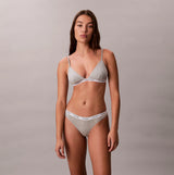 Calvin Klein Icon Logo Womens 3 Pack Thong Multi front view of model wearing thong and bra set in heather gray.