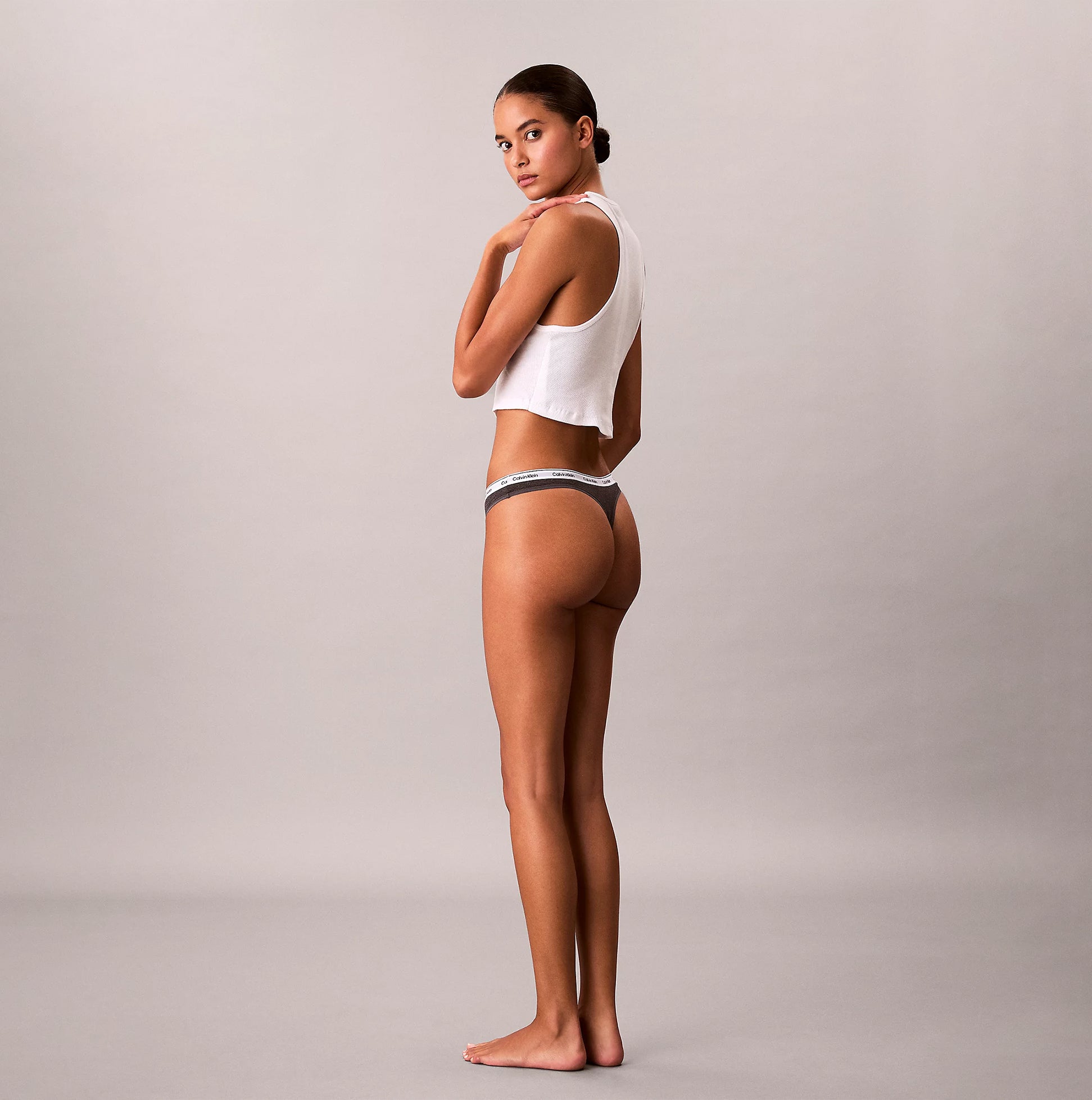 Calvin Klein THONG 3 PACK Womens Thong Multicoloured side view model wearing thong and tank top.