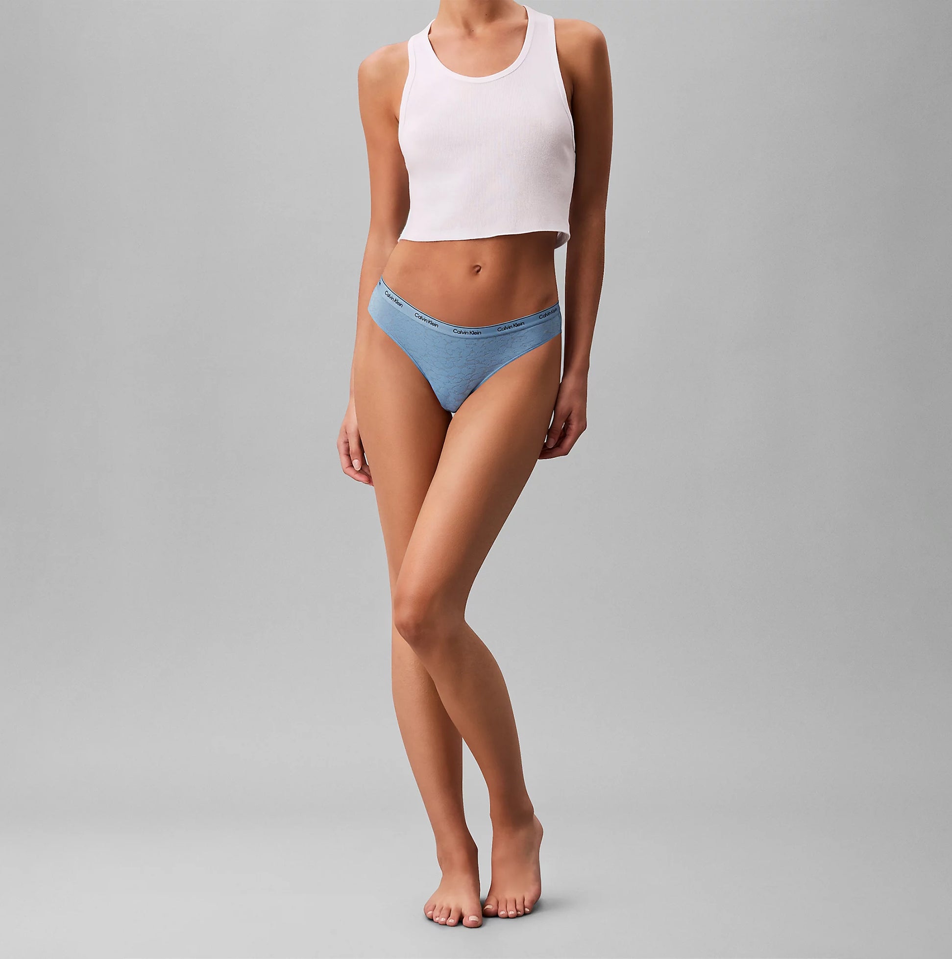 Calvin Klein BRAZILIAN 3 PACK Womens Multicoloured side view model wearing Brazilian underwear and crop top.