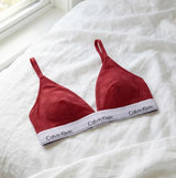Calvin Klein UNLINED TRIANGLE XAT Womens Bra Rouge front view on white fabric with polka dot design and signature underband.