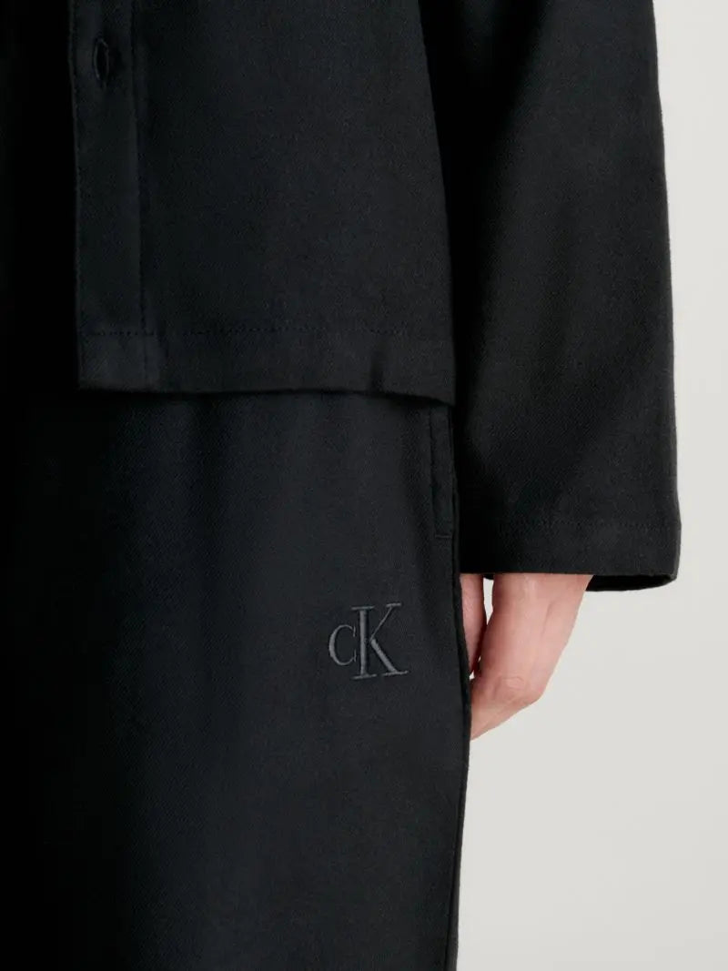 Calvin Klein L/S PANT SET UB1 Womens Pyjamas Black detail view showing fabric and logo on sleeve and pant.