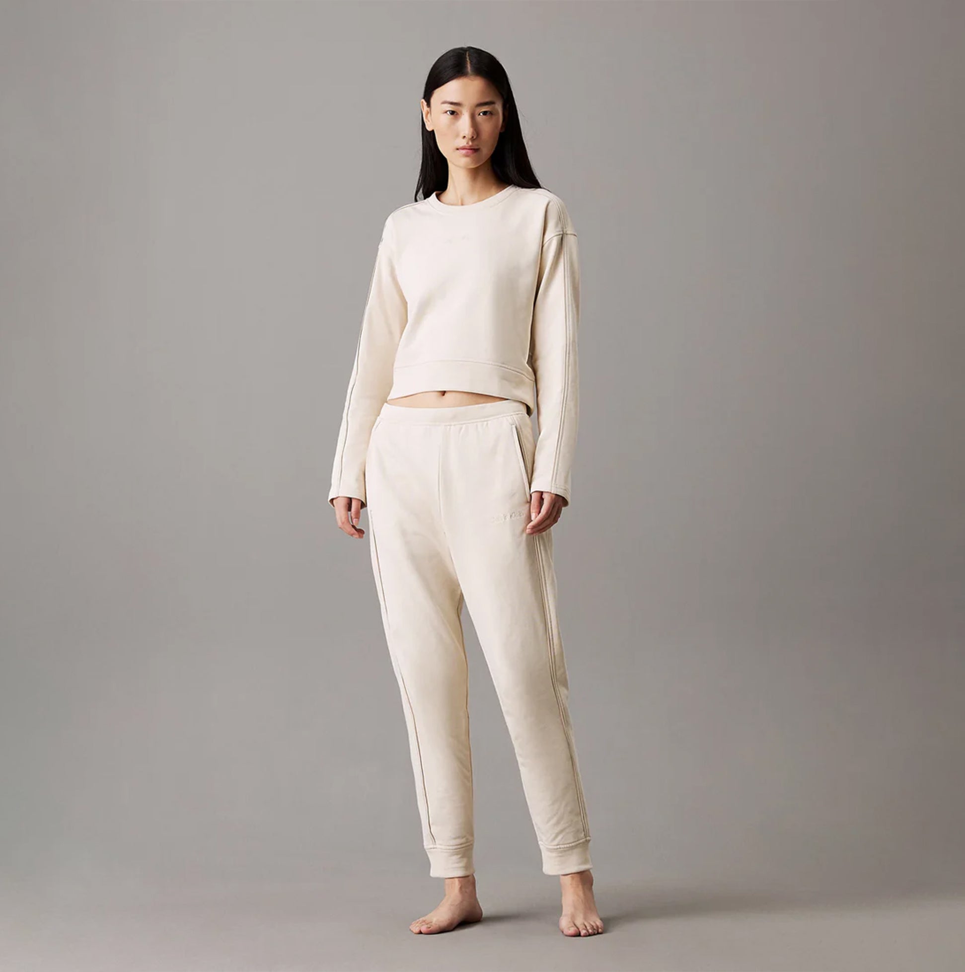 Calvin Klein TONAL LOGO LOUNGE Womens Joggers Sandshell front view on model, showcasing comfort and style.