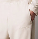 Calvin Klein TONAL LOGO LOUNGE Womens Joggers Sandshell detail view showcasing pocket and logo.
