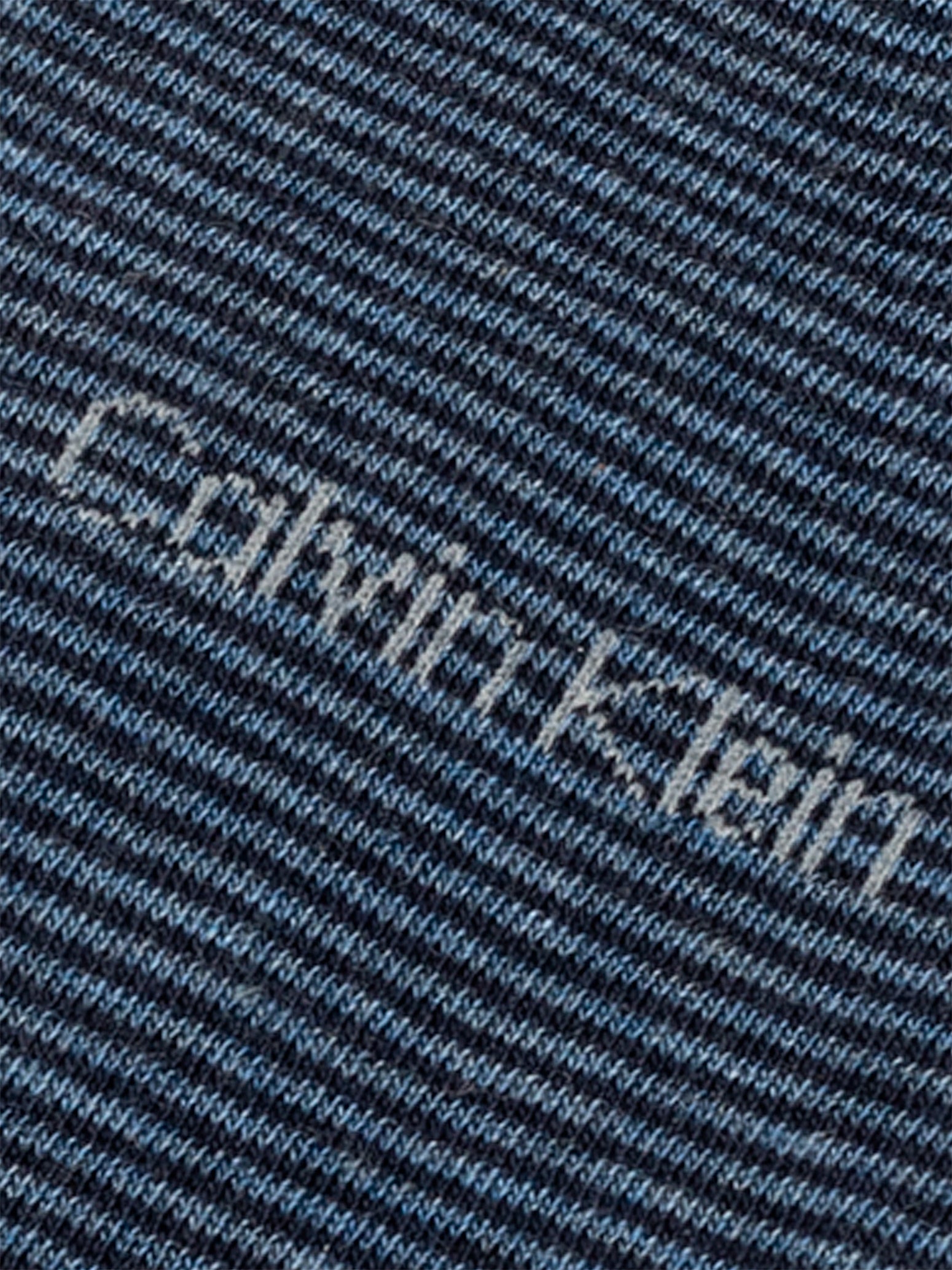 Calvin Klein 4 Pack Giftboxed Classic Mens Crew Socks Blue close up detail view showing logo pattern on fabric.