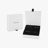 Calvin Klein 4 Pack Giftbox Classic Mens Socks Black displayed in an open gift box, featuring four pairs of black crew socks.