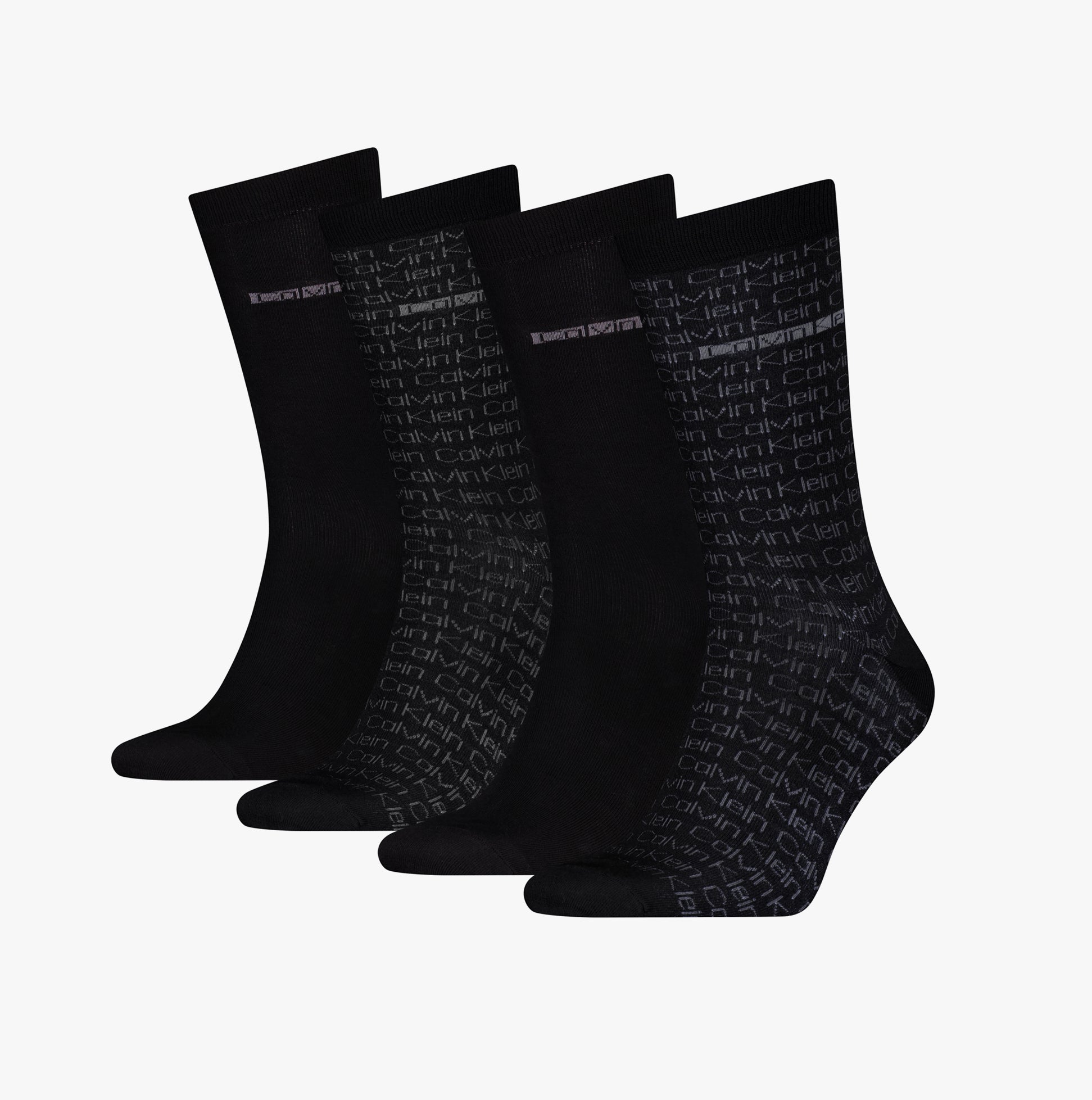Calvin Klein 4 Pack Giftbox AOP Mens Socks Black, front view showing four pairs of black crew socks with logo patterns.