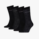 Calvin Klein 4 Pack Giftbox AOP Mens Socks Black, front view showing four pairs of black crew socks with logo patterns.