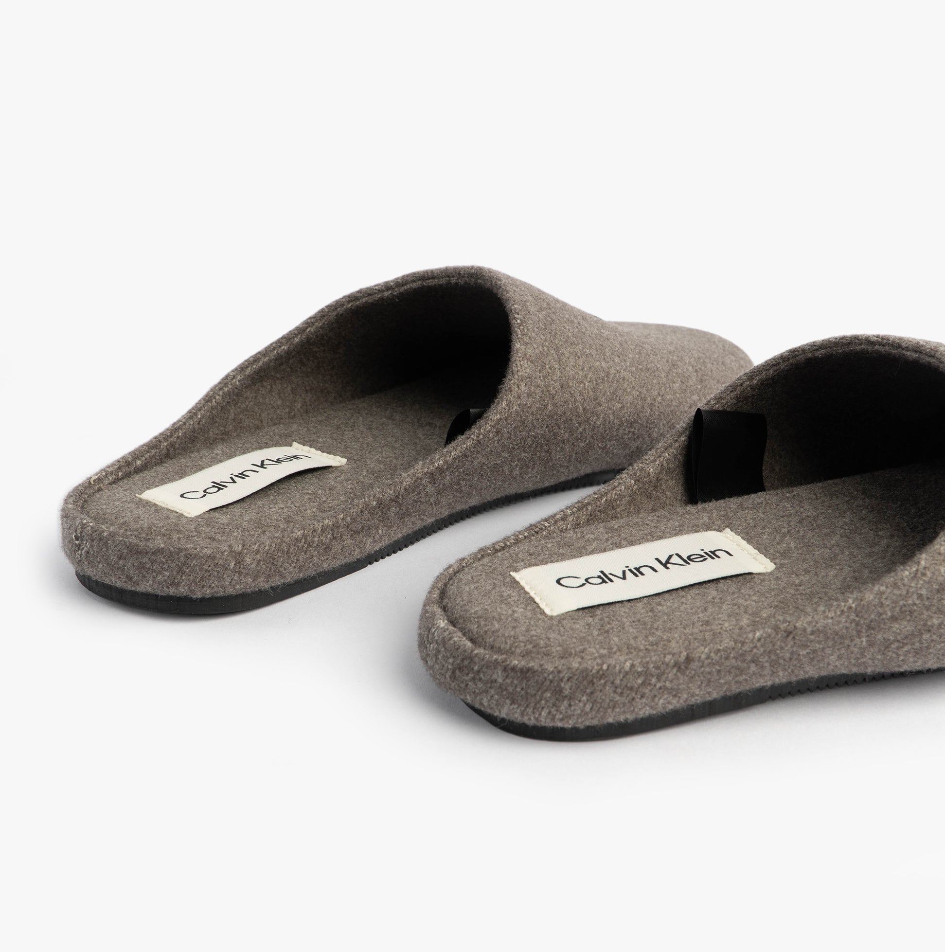 Calvin Klein Mens HOME Felt Signature Logo Mule Slippers Grey side view showing soft felt upper and label.