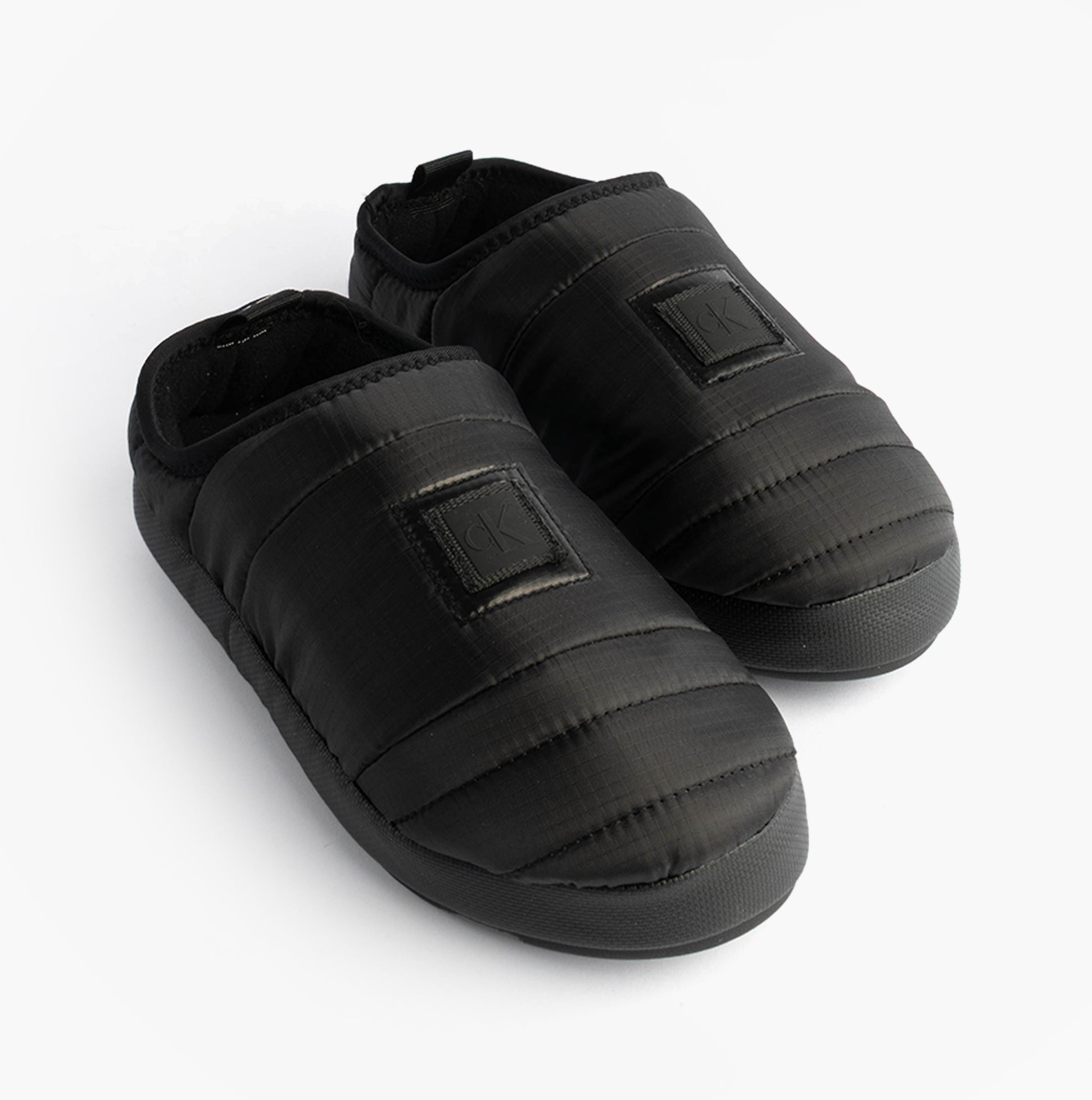 Calvin Klein HOME SLIPPER NYL PAT Womens Slippers Black, top view of black slip-on full slippers with quilted design.