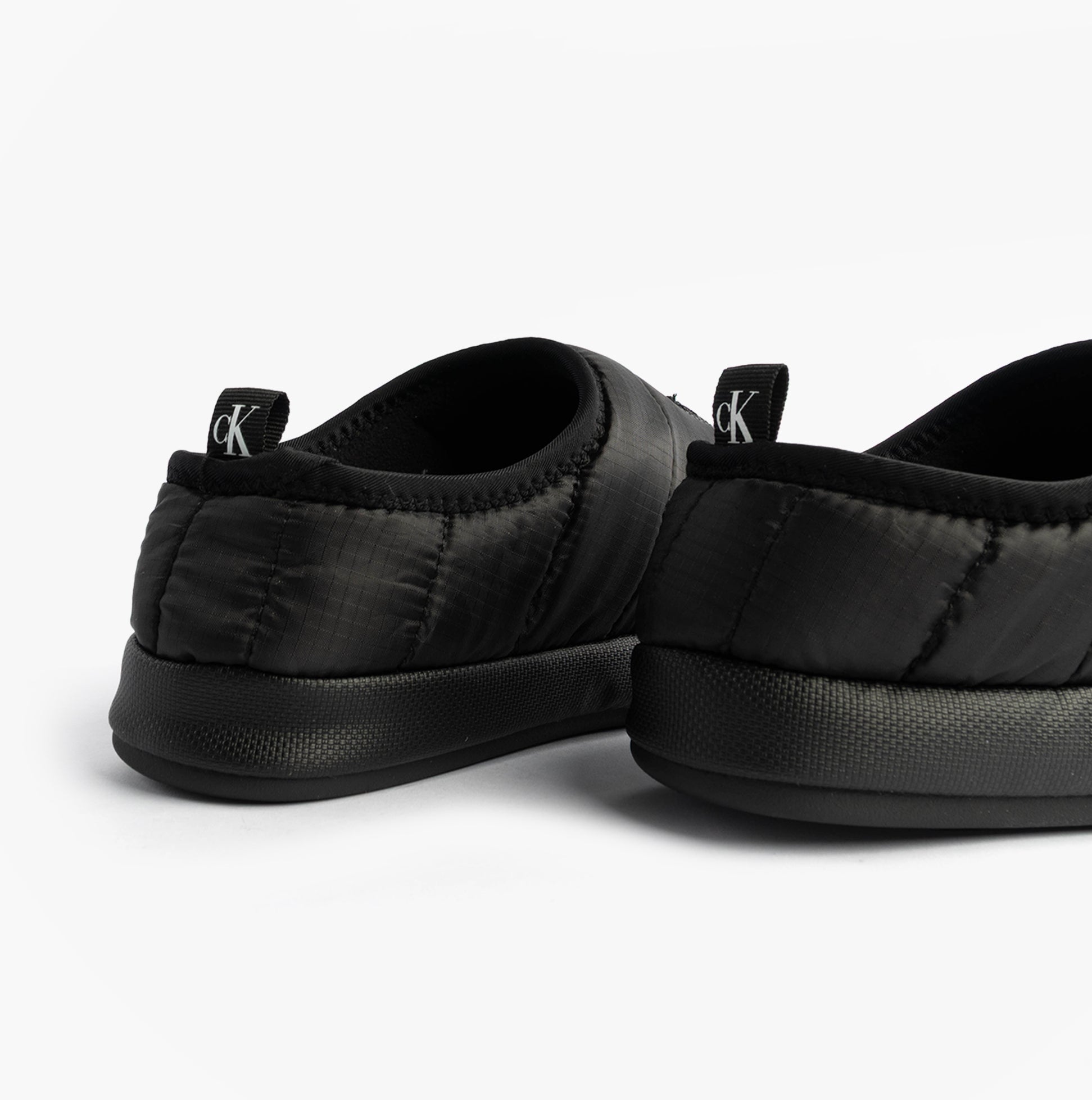 Calvin Klein HOME SLIPPER NYL PAT Womens Slippers Black rear view detailing soft polyester material and lightweight construction.