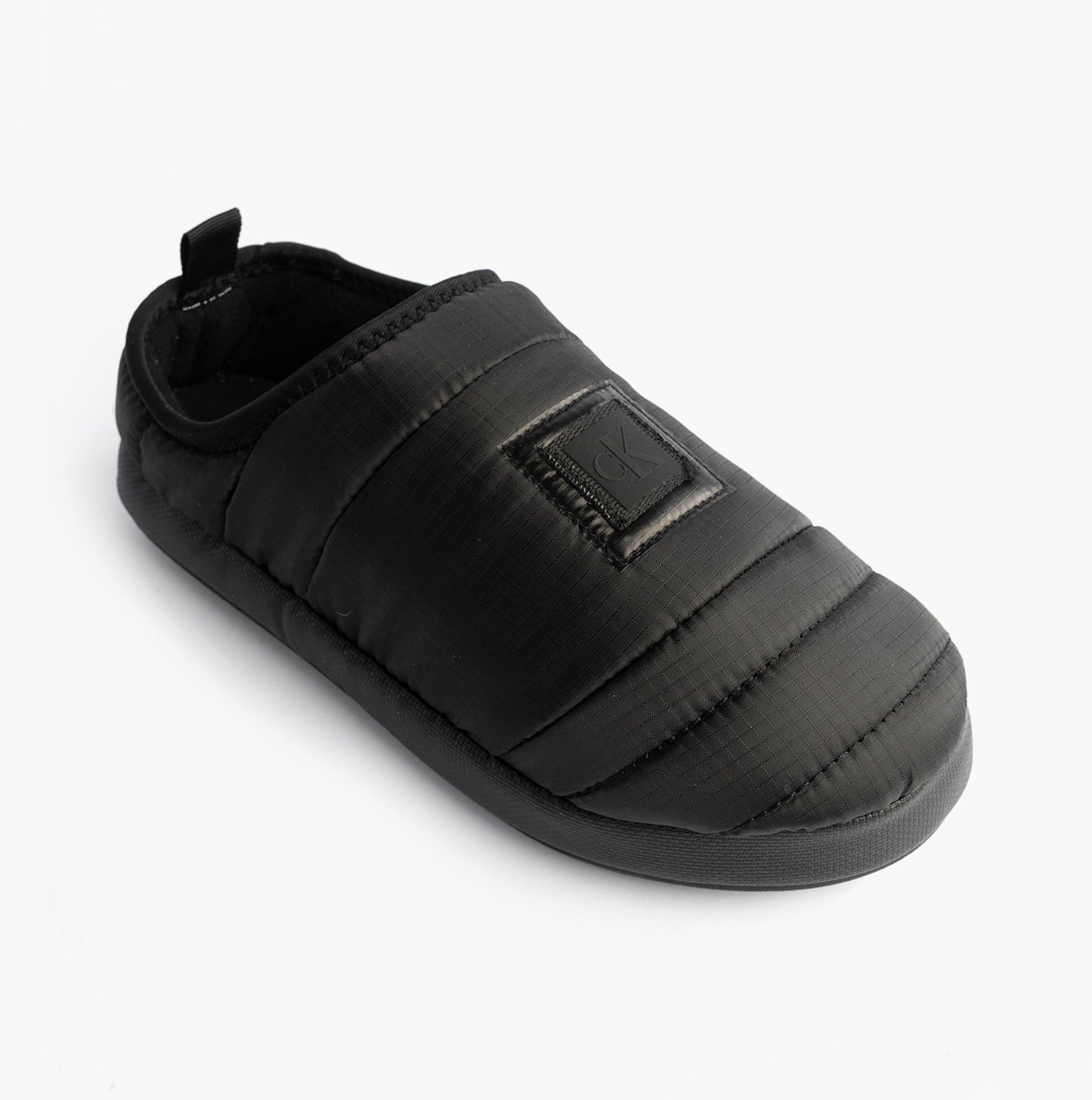 Calvin Klein HOME SLIPPER NYL PAT Womens Slippers Black side view of lightweight, slip-on comfort slippers.