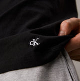 Calvin Klein 100% COTTON 3 Pack Mens T-Shirts Black/Grey Heather/White detail view of CK embroidery on black t-shirt.
