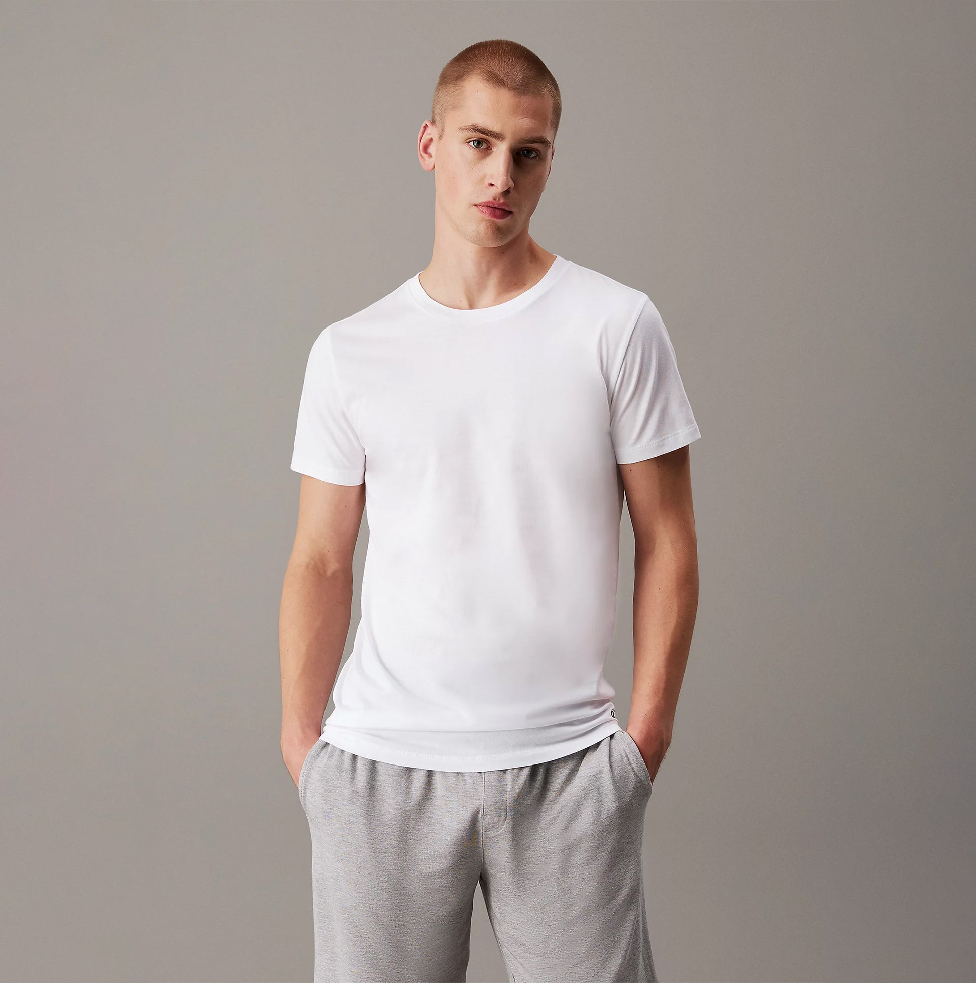Calvin Klein 100% COTTON 3 Pack Mens T-Shirts Black/Grey Heather/White front view on model wearing white t-shirt.