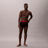 Calvin Klein TRUNK Mens 5 PACK Multicoloured front view of model wearing black trunk underwear with red waistband.
