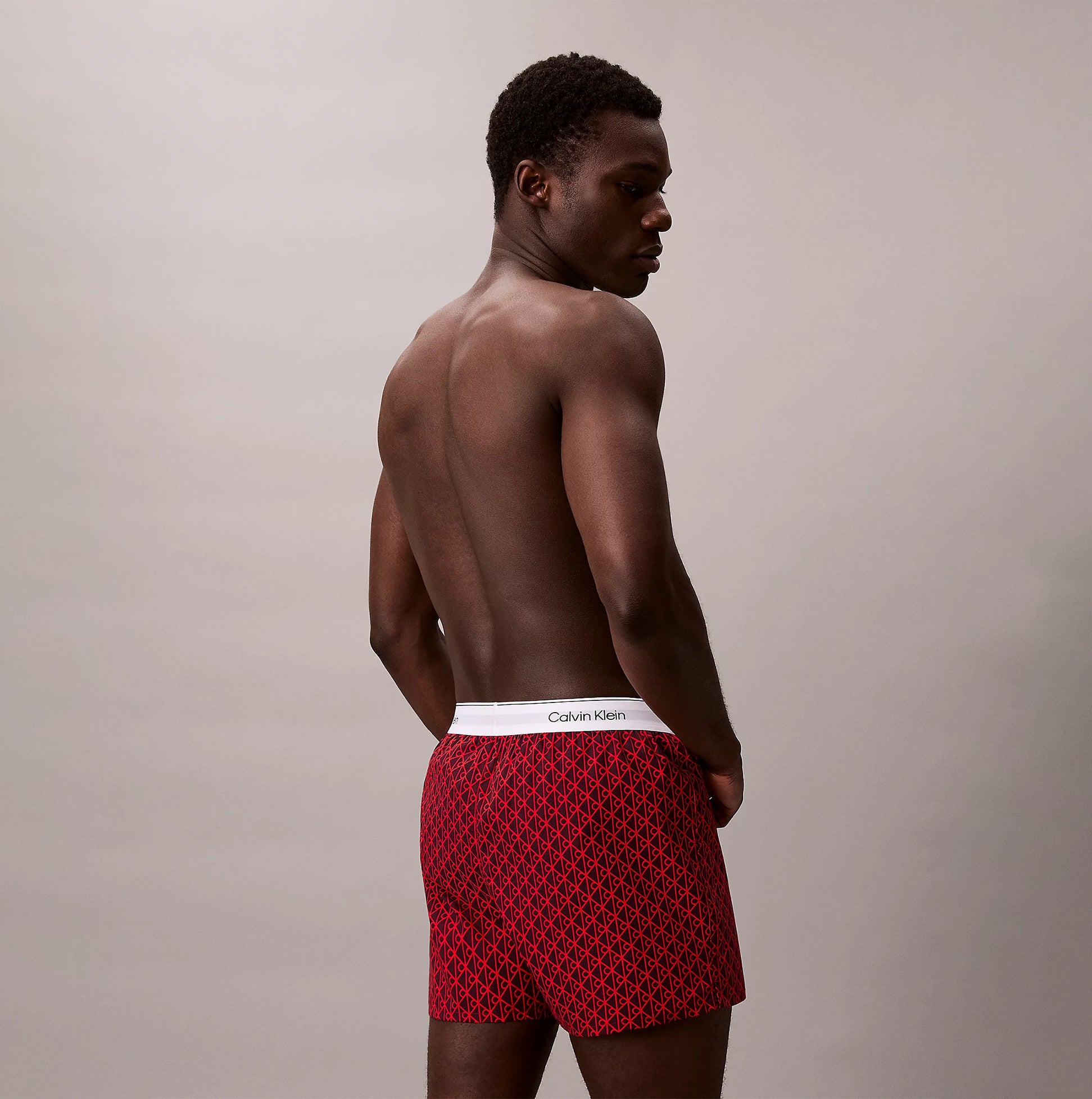 Calvin Klein BOXER SLIM 3 Pack Mens Cotton Stretch Multicoloured side view of model wearing red boxer shorts.