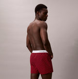 Calvin Klein BOXER SLIM 3 Pack Mens Cotton Stretch Multicoloured side view of model wearing red boxer shorts.