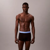 Calvin Klein TRUNK 5 Pack Mens Multicoloured front view model wearing black underwear with blue logo waistband.