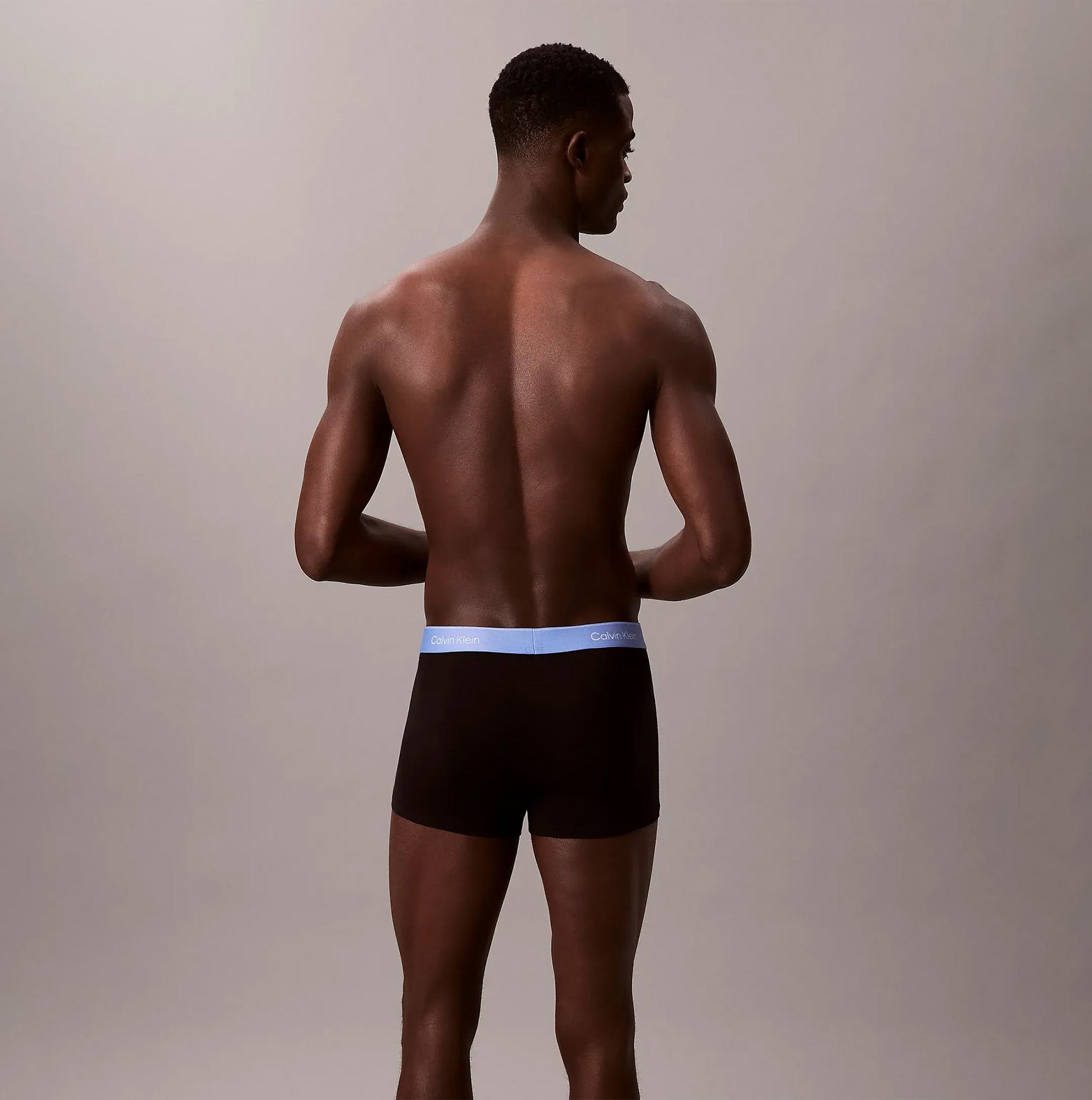 Calvin Klein TRUNK 5 Pack Mens Multicoloured, back view of model wearing black underwear with blue waistband.