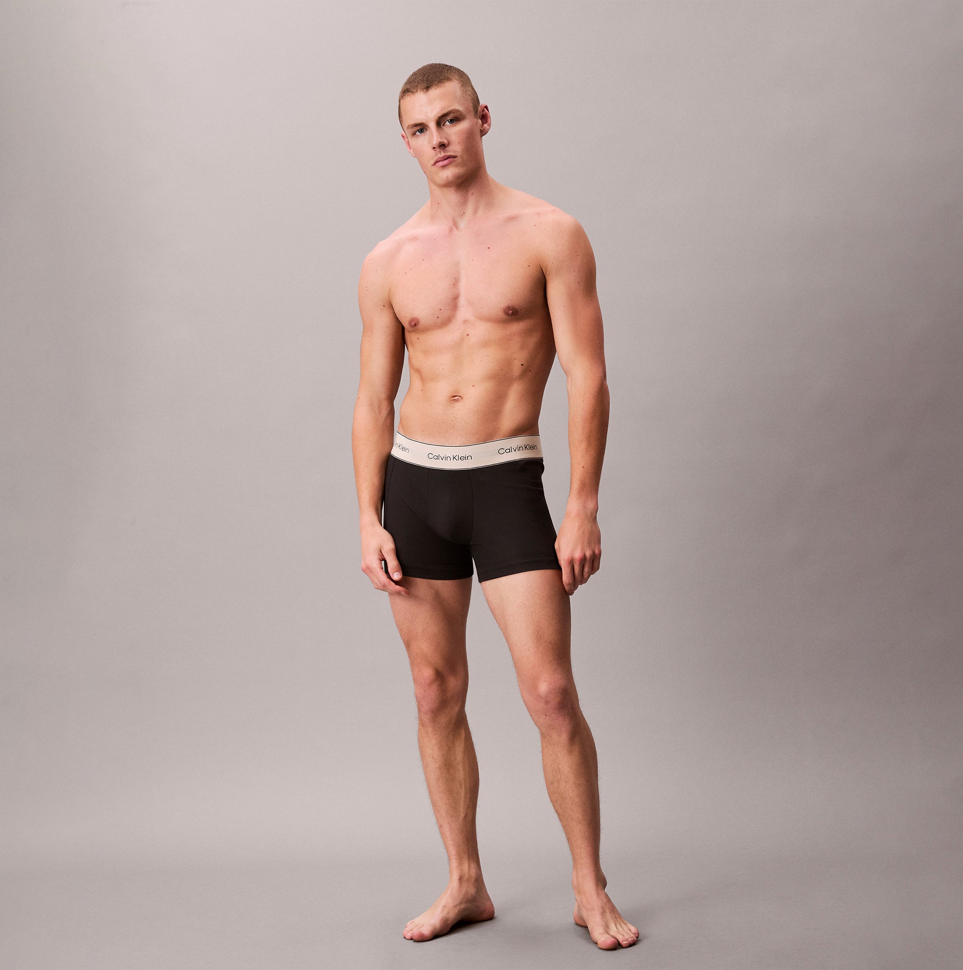Calvin Klein TRUNK 3 Pack Mens Black front view featuring model wearing black trunk underwear with logo waistband.