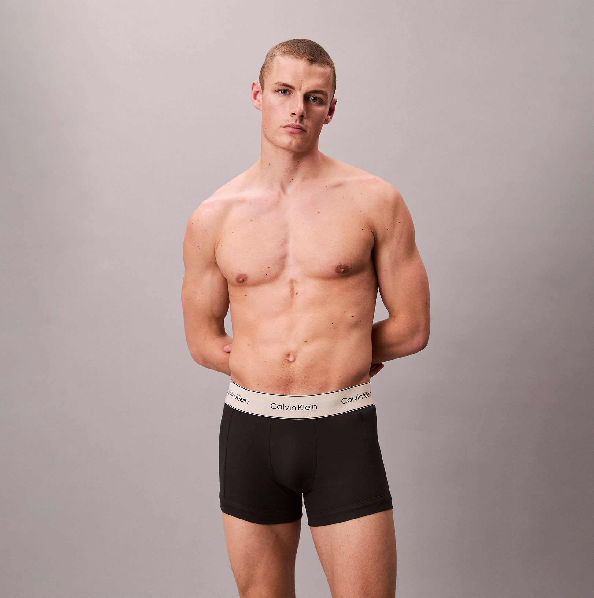 Calvin Klein TRUNK 3 Pack Mens Black front view on model showcasing soft cotton stretch underwear and logo waistband.