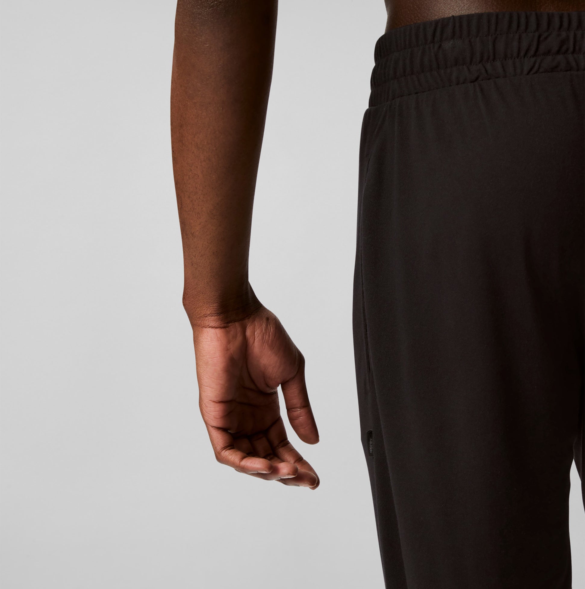 Calvin Klein ULTRA SOFT MODAL Mens Lounge Bottoms Black side view showing waistband and hand detail.