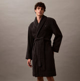 Calvin Klein COMFORT FRENCH TERRY Mens Bathrobes Black front view on model, showcasing soft 100% cotton fabric and long sleeves.