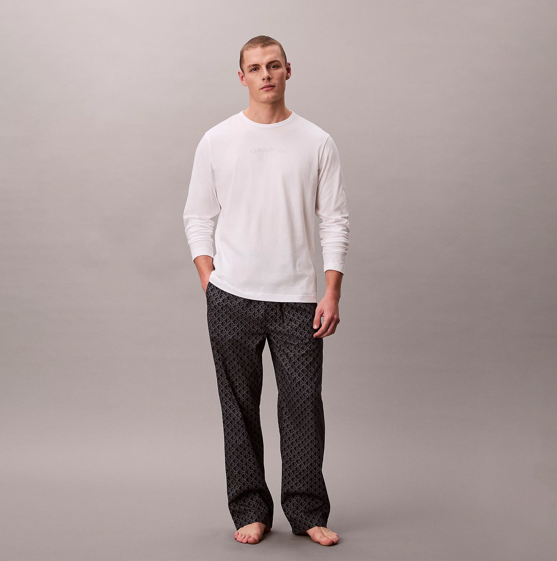 Calvin Klein LS TEE PANT SET Mens Multicoloured front view model wearing white long sleeve tee and patterned pants.