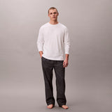 Calvin Klein LS TEE PANT SET Mens Multicoloured front view model wearing white long sleeve tee and patterned pants.