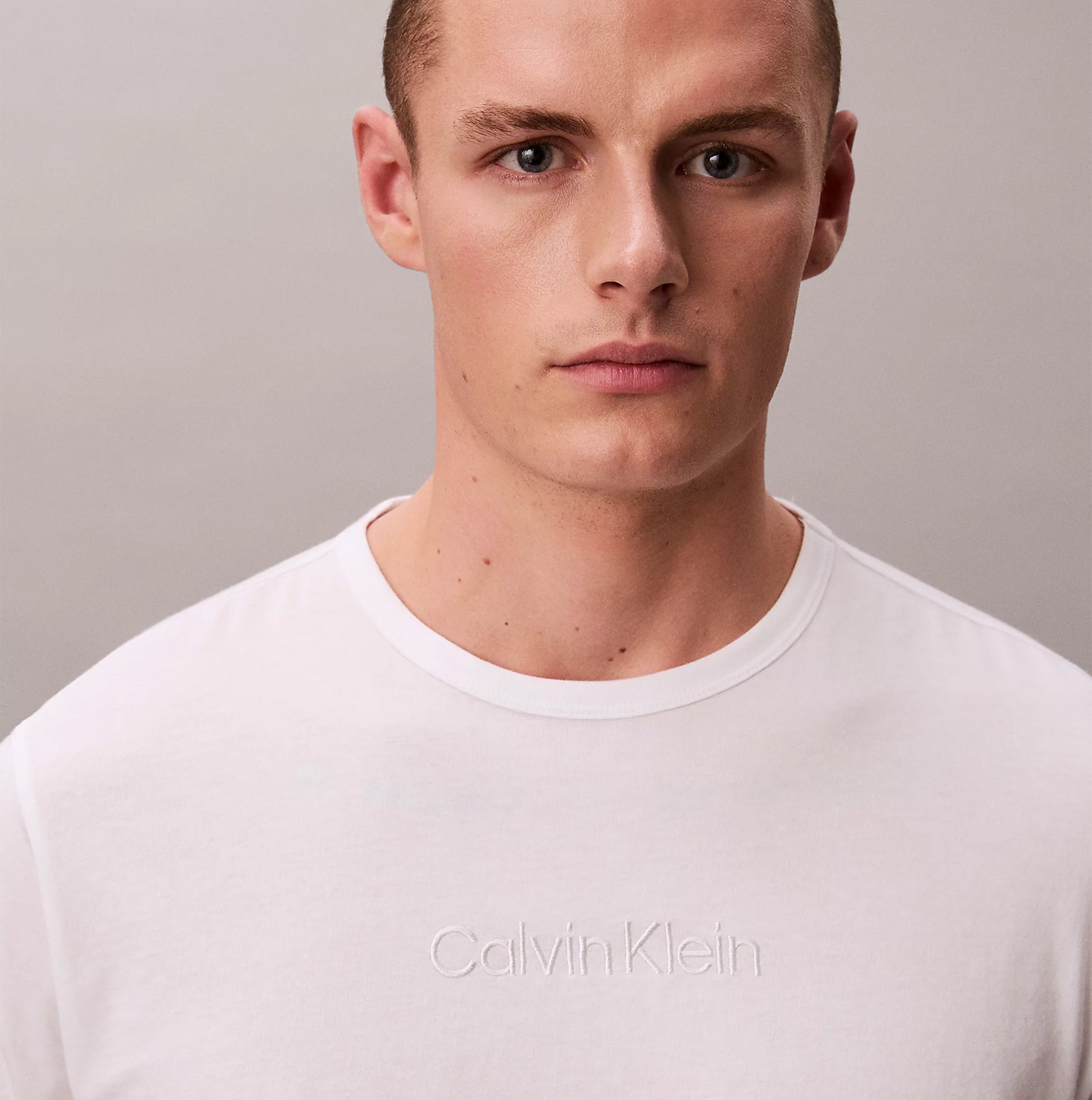 Calvin Klein LS TEE PANT SET Mens Multicoloured front view featuring a model wearing a white Calvin Klein t-shirt with embossed logo.
