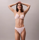 Calvin Klein Bonded Flex Seamless Womens 3 Pack Thong Multi front view of model wearing seamless underwear in pink.