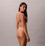 Calvin Klein Bonded Flex Seamless 3 Pack Thong Multi, side view of model wearing thong in neutral color.