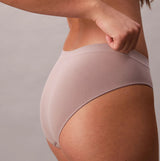 Calvin Klein BIKINI 3 PACK Womens Bikini Multicoloured side view of beige bikini underwear on model