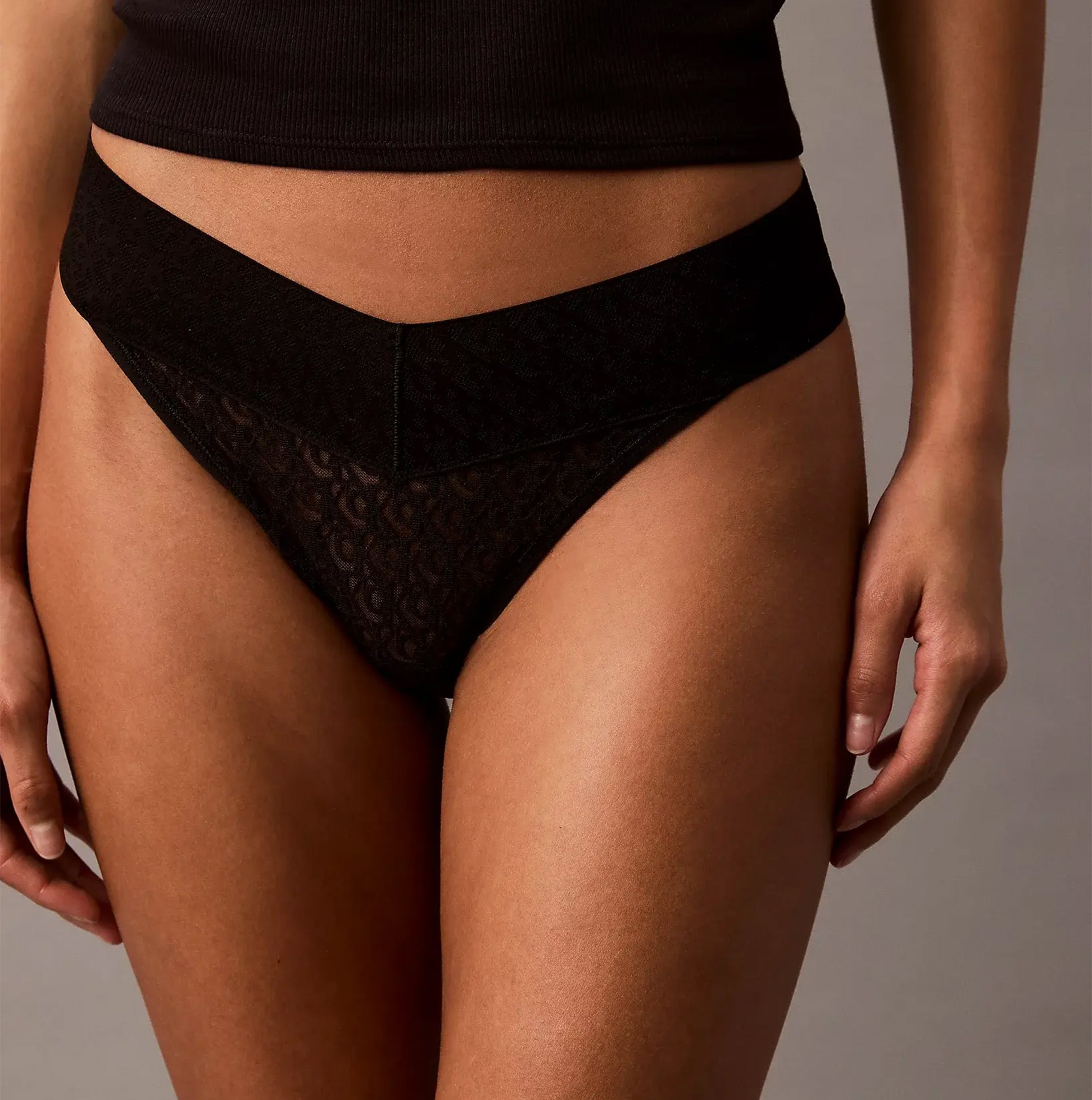 Calvin Klein THONG Womens Icon Logo Lace Molten Black front view, showcasing intricate lace design and sleek silhouette.